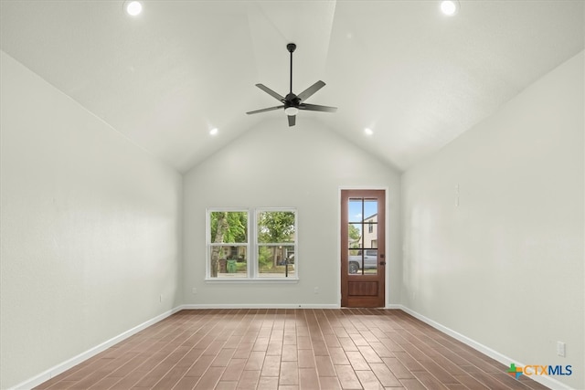 unfurnished room with hardwood / wood-style floors, ceiling fan, and high vaulted ceiling