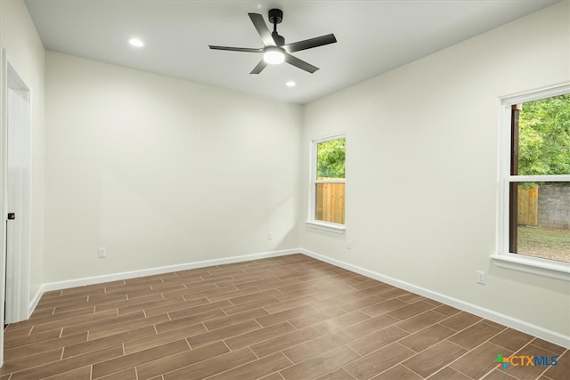 spare room with dark hardwood / wood-style floors and ceiling fan