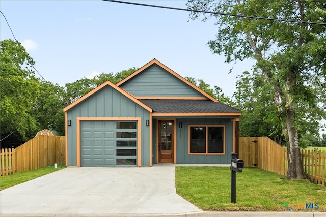 view of front of house with a garage and a front yard