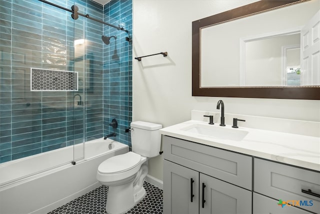 full bathroom with enclosed tub / shower combo, tile patterned flooring, vanity, and toilet