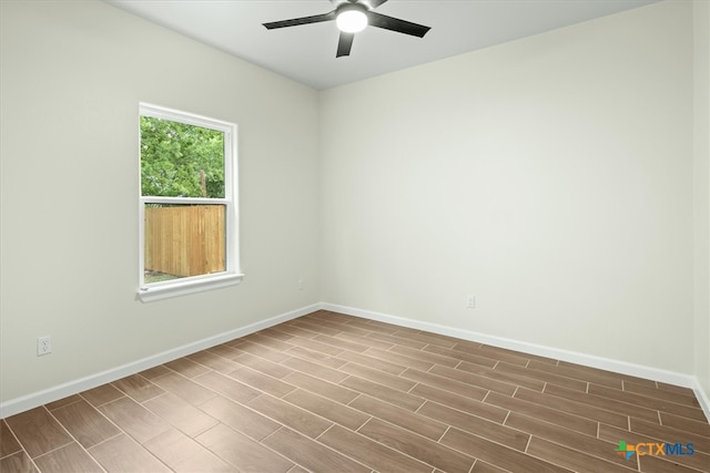 unfurnished room with hardwood / wood-style floors and ceiling fan