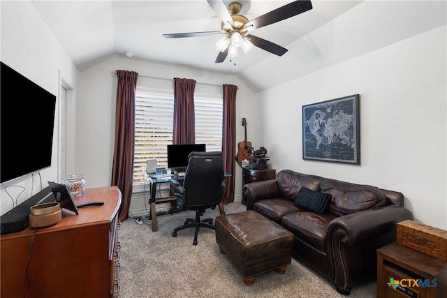 carpeted office space with vaulted ceiling and ceiling fan