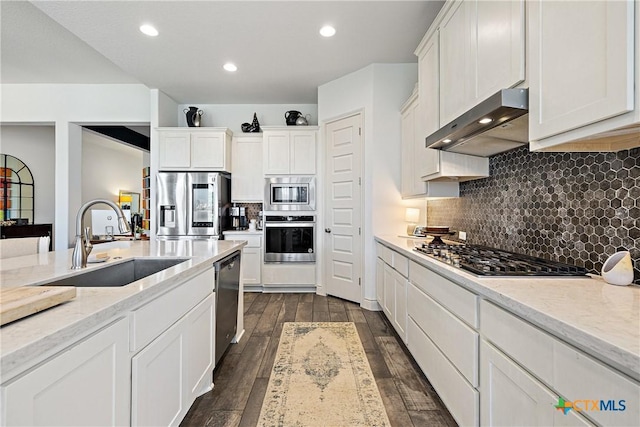 kitchen with white cabinets, extractor fan, sink, and appliances with stainless steel finishes