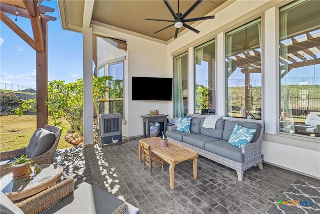 sunroom / solarium with ceiling fan and a healthy amount of sunlight