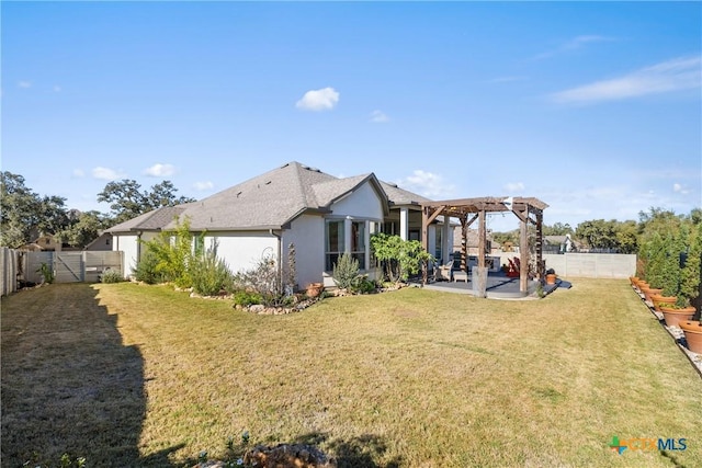 rear view of house featuring a pergola, a yard, and a patio