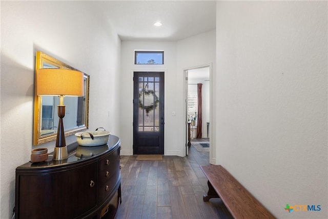 entryway with a towering ceiling and dark hardwood / wood-style floors