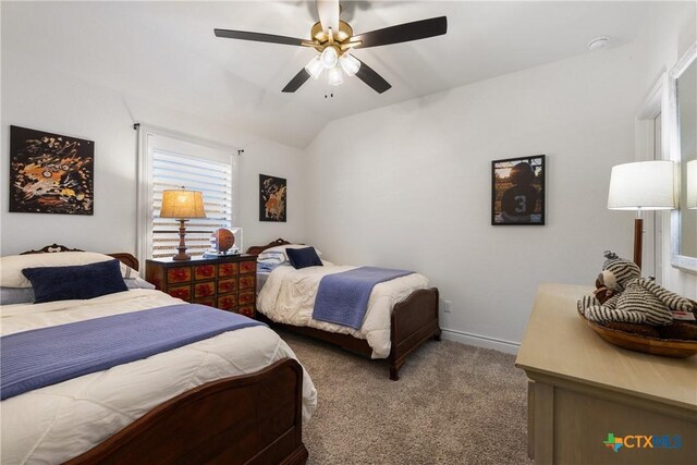 carpeted bedroom featuring ceiling fan and lofted ceiling