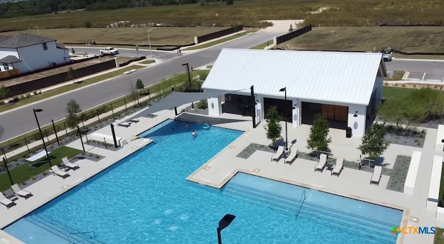 pool featuring fence and a patio area