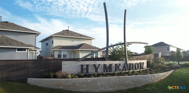 community / neighborhood sign with fence