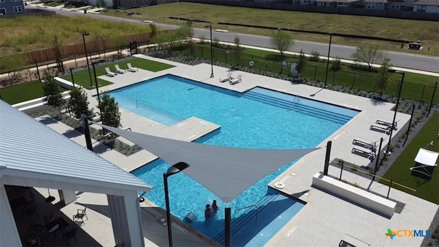 community pool with a gazebo, fence, and a patio