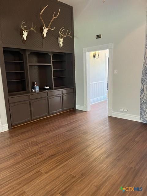 716 Josephine St, Yoakum, TX 77995 - unfurnished living room with wood finished floors and baseboards