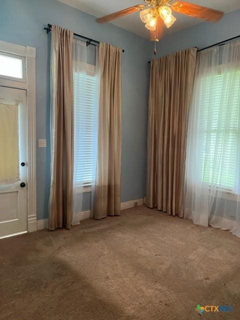 716 Josephine St, Yoakum, TX 77995 - spare room featuring healthy amount of natural light, carpet floors, and a ceiling fan