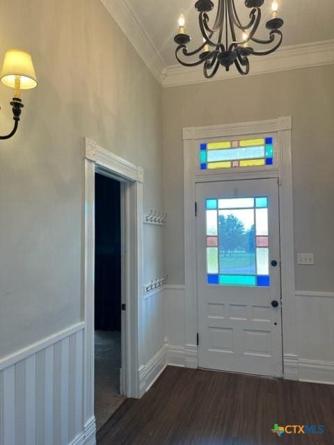 716 Josephine St, Yoakum, TX 77995 - entryway featuring a chandelier, crown molding, and dark wood finished floors