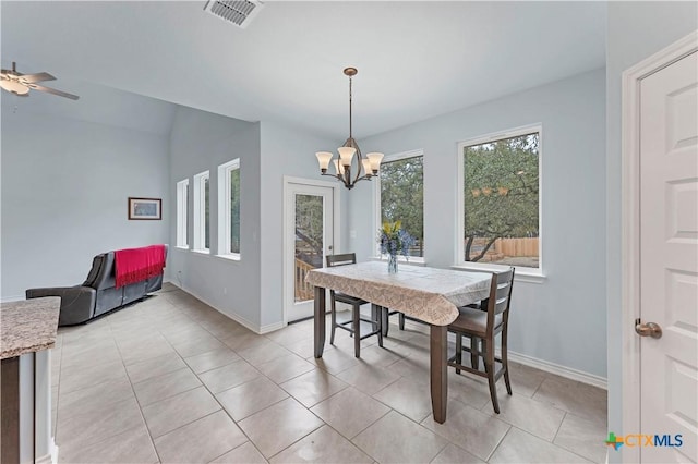 dining space with ceiling fan with notable chandelier, visible vents, baseboards, and light tile patterned floors