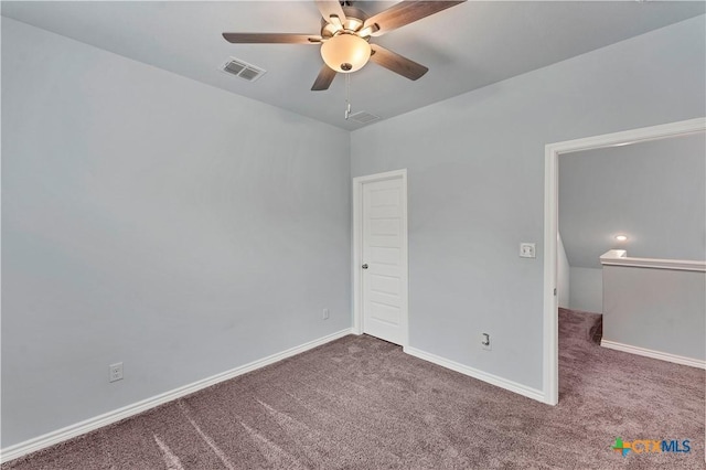 unfurnished bedroom with carpet floors, a ceiling fan, visible vents, and baseboards