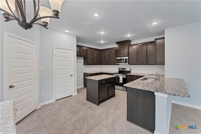 kitchen with stainless steel appliances, visible vents, a sink, dark brown cabinets, and light stone countertops