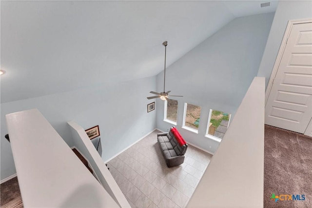 interior space featuring lofted ceiling, carpet flooring, and an upstairs landing