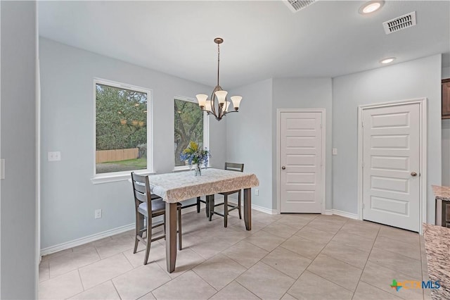 dining room with light tile patterned floors, baseboards, visible vents, and a notable chandelier