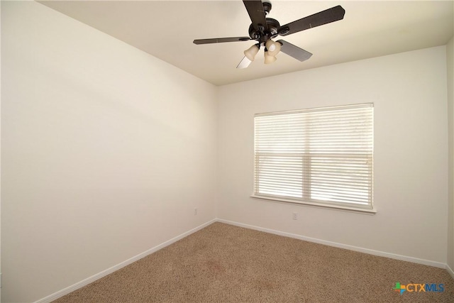 unfurnished room with baseboards, a ceiling fan, and light colored carpet