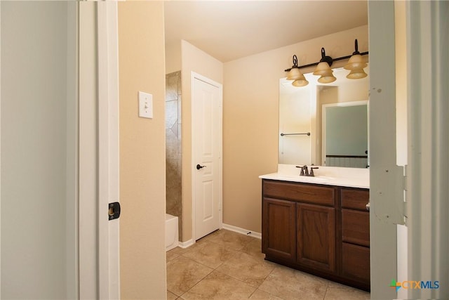 full bath featuring tile patterned flooring, vanity, and baseboards