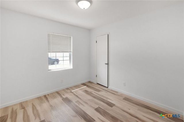 unfurnished room with light hardwood / wood-style flooring