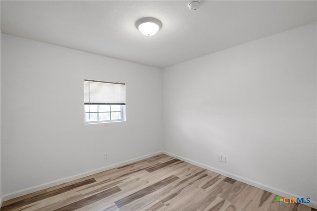 spare room featuring light hardwood / wood-style floors