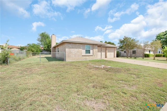 view of front of home with a garage and a front lawn