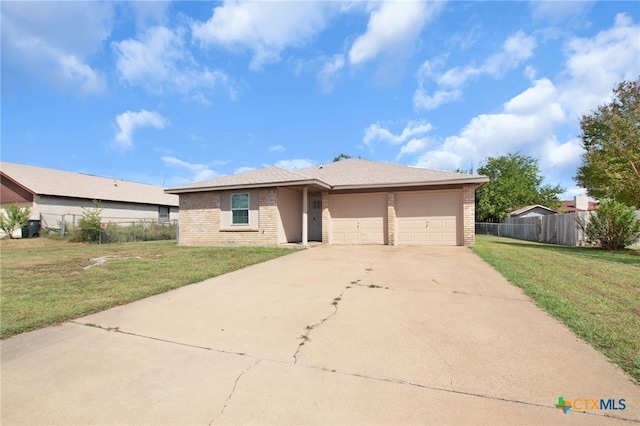 view of front of home featuring a garage and a front lawn