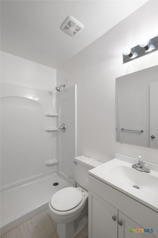 bathroom with a shower, tile patterned floors, toilet, and vanity