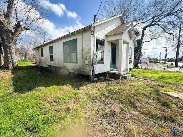 view of property exterior with a yard