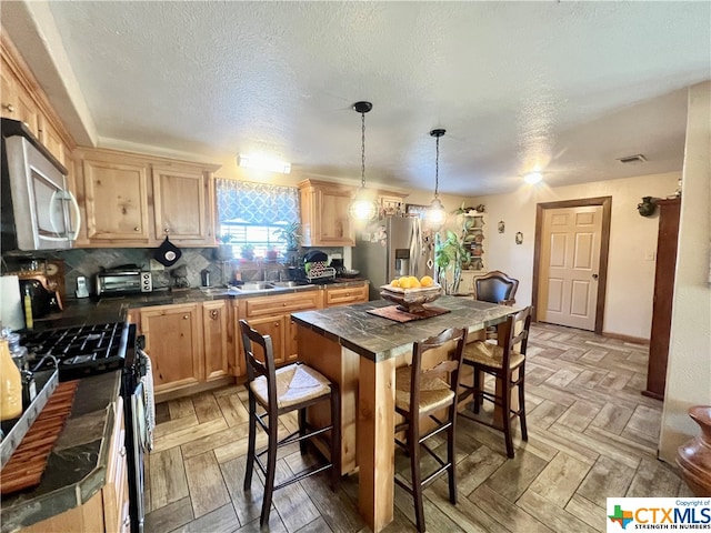 kitchen featuring stainless steel appliances, a center island, light parquet floors, tasteful backsplash, and pendant lighting