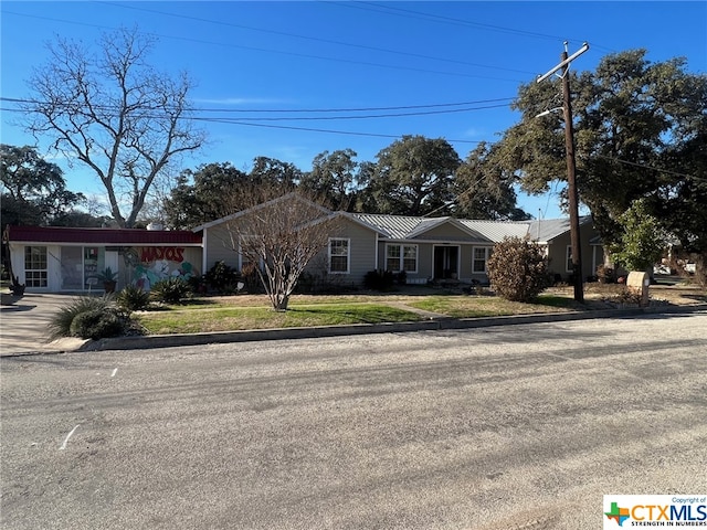 ranch-style house with a front lawn