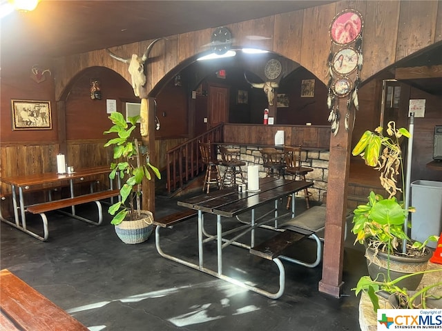 dining space featuring wood walls