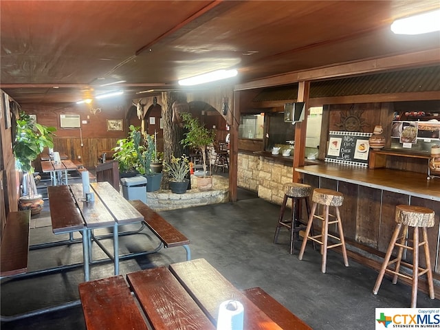 basement featuring wood walls