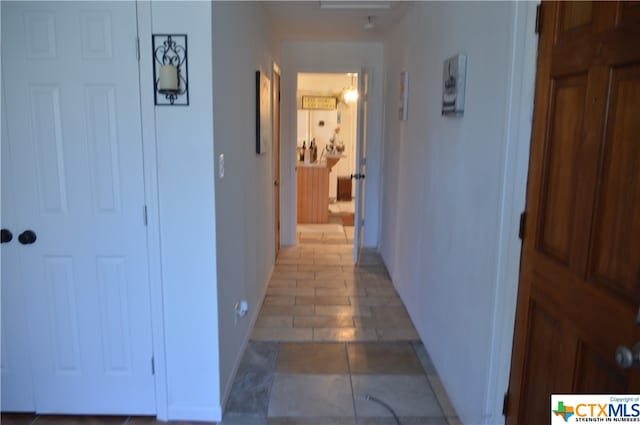 hall with tile patterned flooring