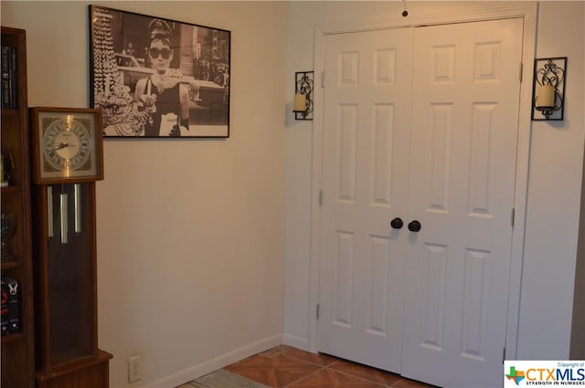 foyer with dark tile patterned floors