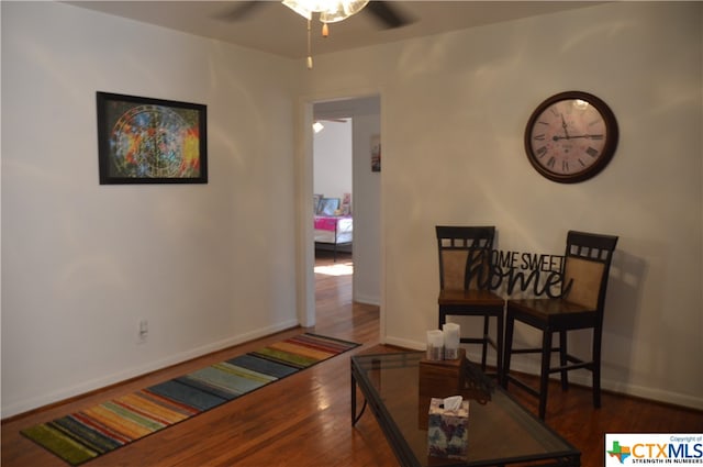 interior space with ceiling fan and dark hardwood / wood-style floors