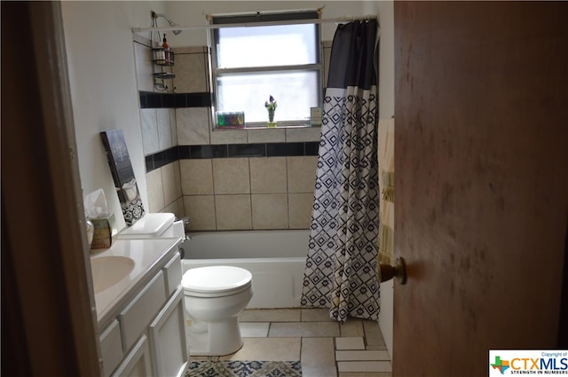 full bathroom with tile patterned flooring, vanity, shower / bath combo with shower curtain, and toilet