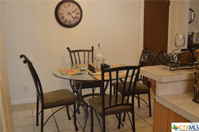 dining area featuring light tile patterned floors