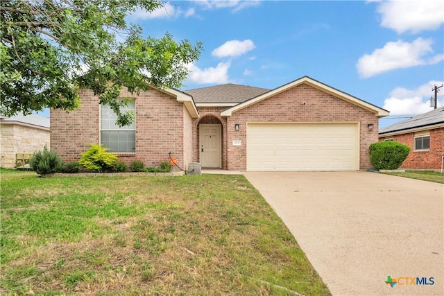 3037 Rain Dance Loop, Harker Heights, TX 76548 - single story home featuring brick siding, an attached garage, and a front lawn