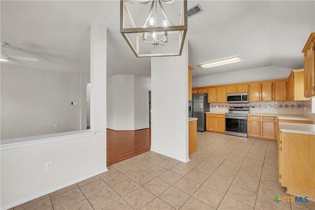 3037 Rain Dance Loop, Harker Heights, TX 76548 - kitchen featuring appliances with stainless steel finishes, vaulted ceiling, light countertops, light tile patterned floors, and tasteful backsplash