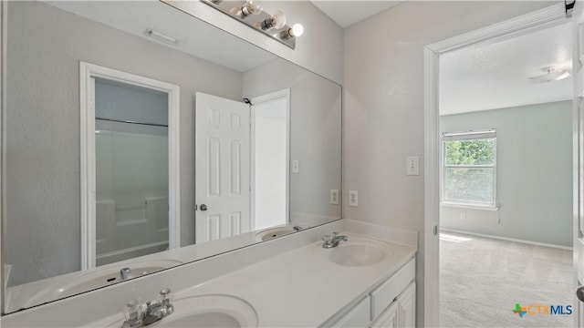 2166 Jolie Ct, New Braunfels, TX 78130 - bathroom featuring double vanity and baseboards