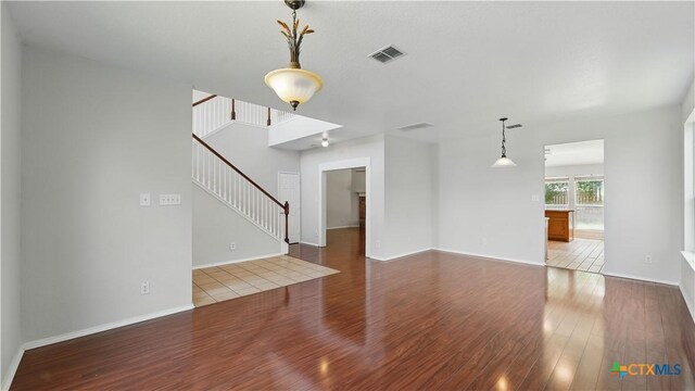 2166 Jolie Ct, New Braunfels, TX 78130 - unfurnished living room featuring wood finished floors and stairs