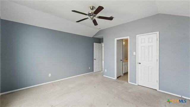 2166 Jolie Ct, New Braunfels, TX 78130 - unfurnished bedroom with vaulted ceiling, light carpet, connected bathroom, and a ceiling fan