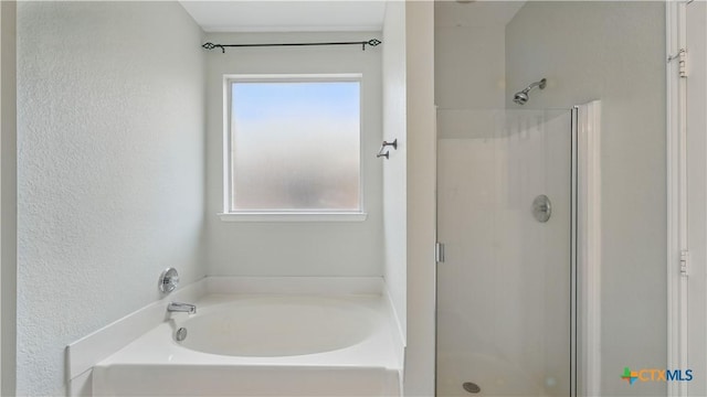 2166 Jolie Ct, New Braunfels, TX 78130 - bathroom featuring a shower stall, a bath, plenty of natural light, and a textured wall