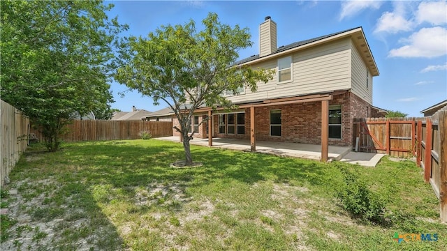 2166 Jolie Ct, New Braunfels, TX 78130 - rear view of property featuring brick siding, a chimney, a fenced backyard, and a patio area