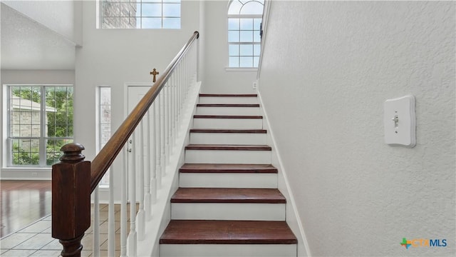 2166 Jolie Ct, New Braunfels, TX 78130 - staircase featuring a textured wall and a high ceiling