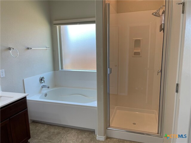 bathroom with vanity, tile patterned floors, and plus walk in shower