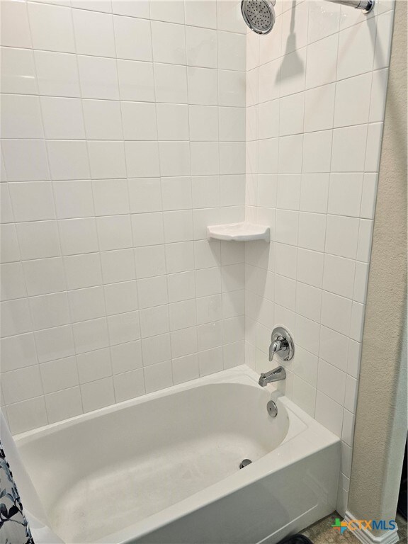 bathroom featuring shower / bath combo with shower curtain