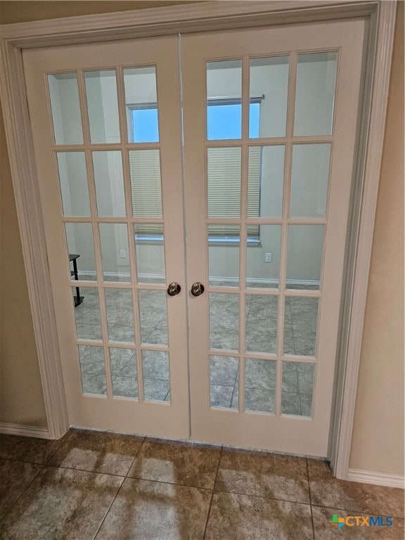 doorway with tile patterned flooring and french doors